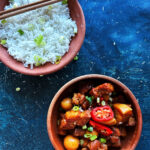 Thit Kho tao in a serving bowl next to a bowl of rice.