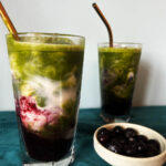 Adding the matcha over the blueberry syrup and milk.